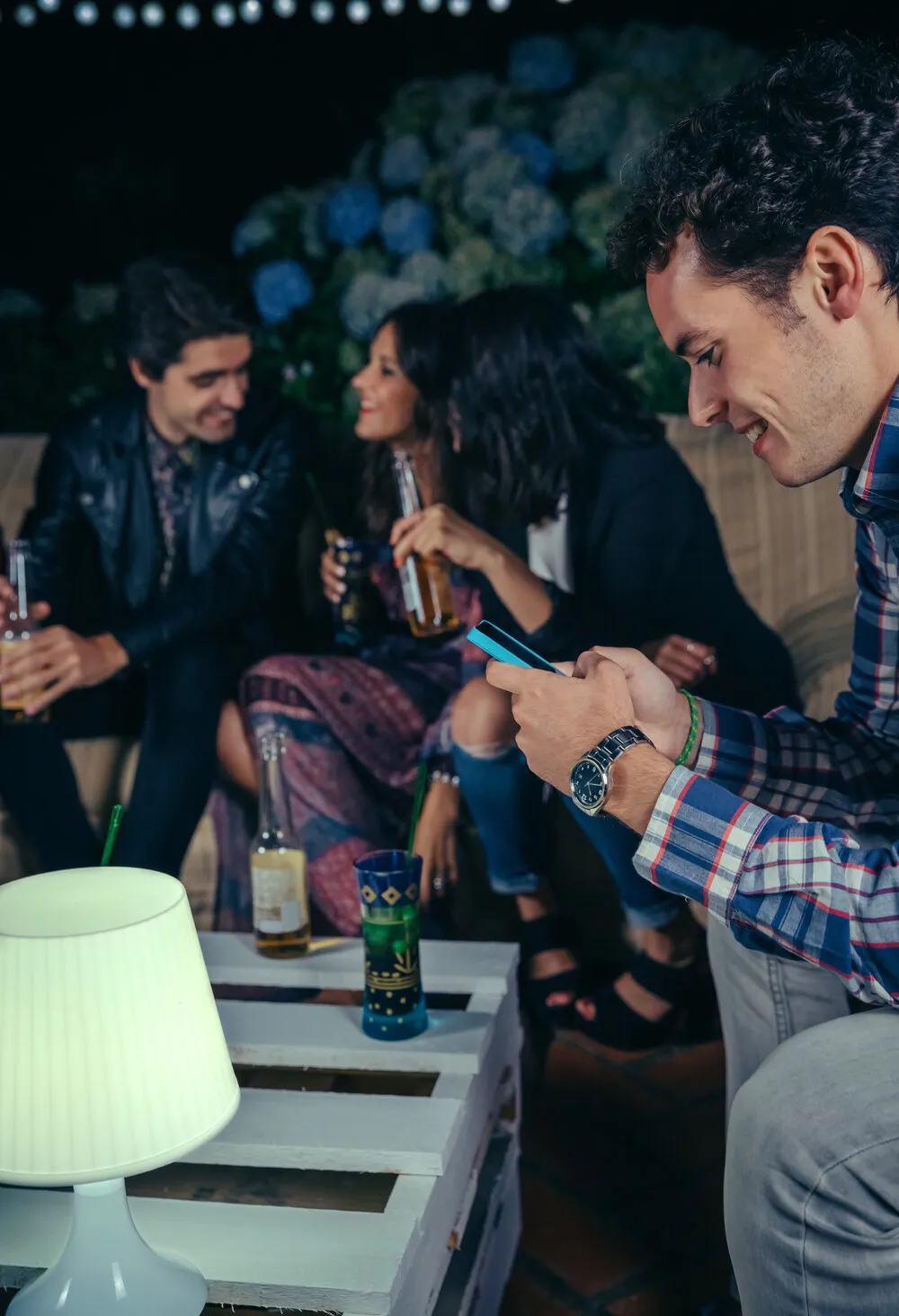 Friends at a venue, one checking the nYtevibe app